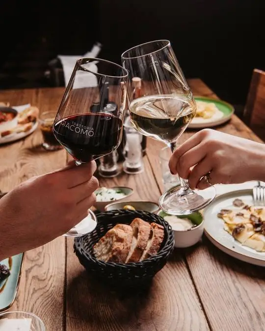 mit Wein beim essen anstoßen